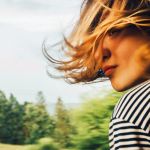 Femme cheveux au vent à la fenêtre d'un train