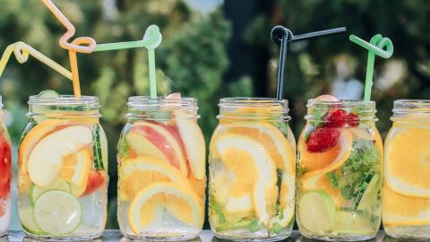 Bocaux maisons en verre remplis de jus avec des fruits