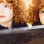 Deux filles rousses qui regardent un écran