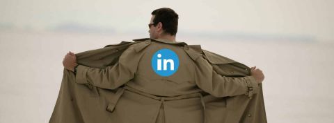 Sur LinkedIn, 90 % des femmes ont reçu des messages à caractère sexuel Homme de dos avec un imperméable ouvert- Logo LinkedIn au dos de l'imperméable