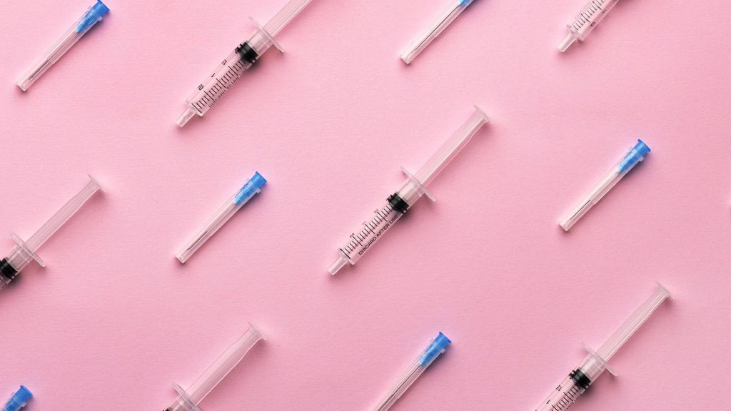 Des seringues sur fond rose