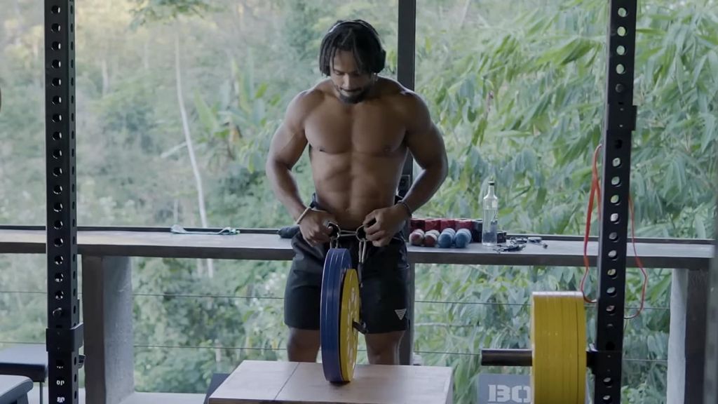 Un homme métissé fait de la musculation avec en fond la jungle de Bali