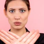 Une jeune femme qui dit non avec ses mains