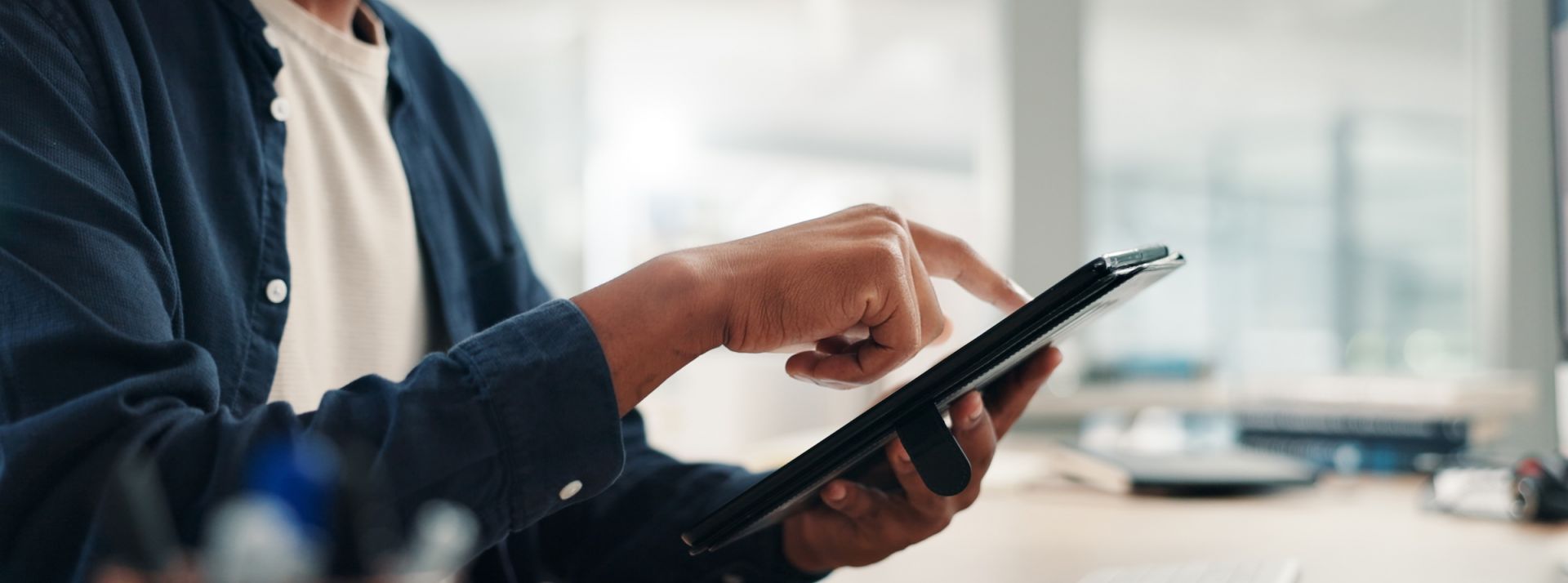 Businessman, hands and tablet in office for research, project planning and scroll on networking platform. Employee, tech and typing at desk for communication, email draft or browsing for productivity - L'ADN