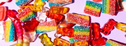 Additifs alimentaires : l’heure du choix Des bonbons sur fond rose