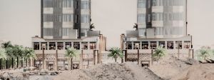 Deux immeubles modernes au Koweit derière des monceaux de sable et des palmiers